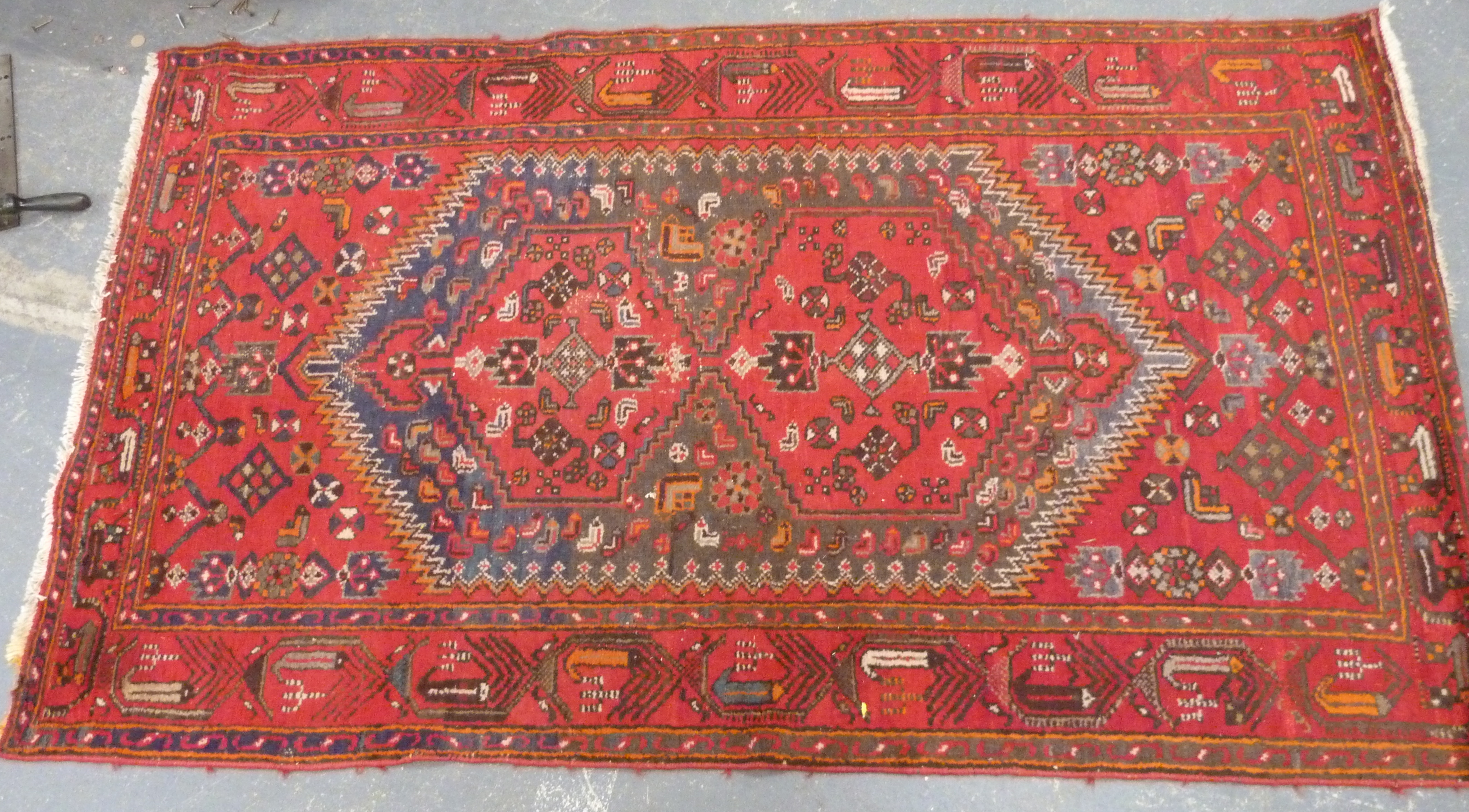 Persian wool carpet with double hexagonal medallions in hexagonal lozenge on red field, 213cm x