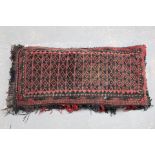Afghan wool on cotton bag or pillow in red and black, 48cm x 104cm.
