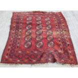 Persian wool rug with three rows of Tekke guls, 155cm x 132cm.