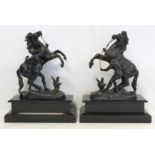 Pair of black spelter Marley horses on black slate plinth bases, each 40cm high.  (2).
