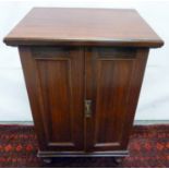 Mahogany cabinet enclosed by pair of panel doors on turned supports, 56cm long, 45cm wide, 80cm high