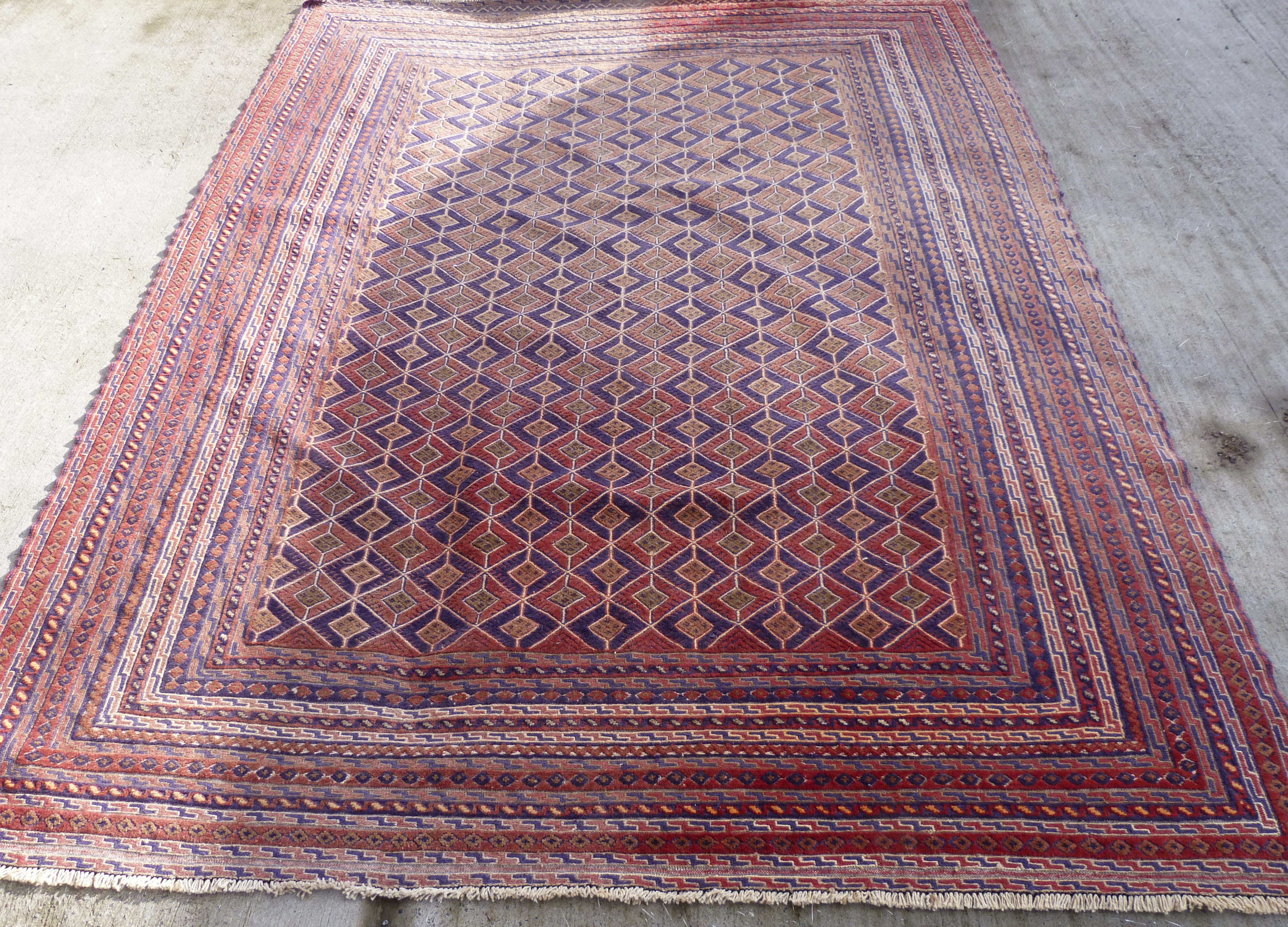 Afghan Mushwani wool carpet with diamond lattice field, in red, blue and ochre, 271cm x 203cm. - Image 3 of 4