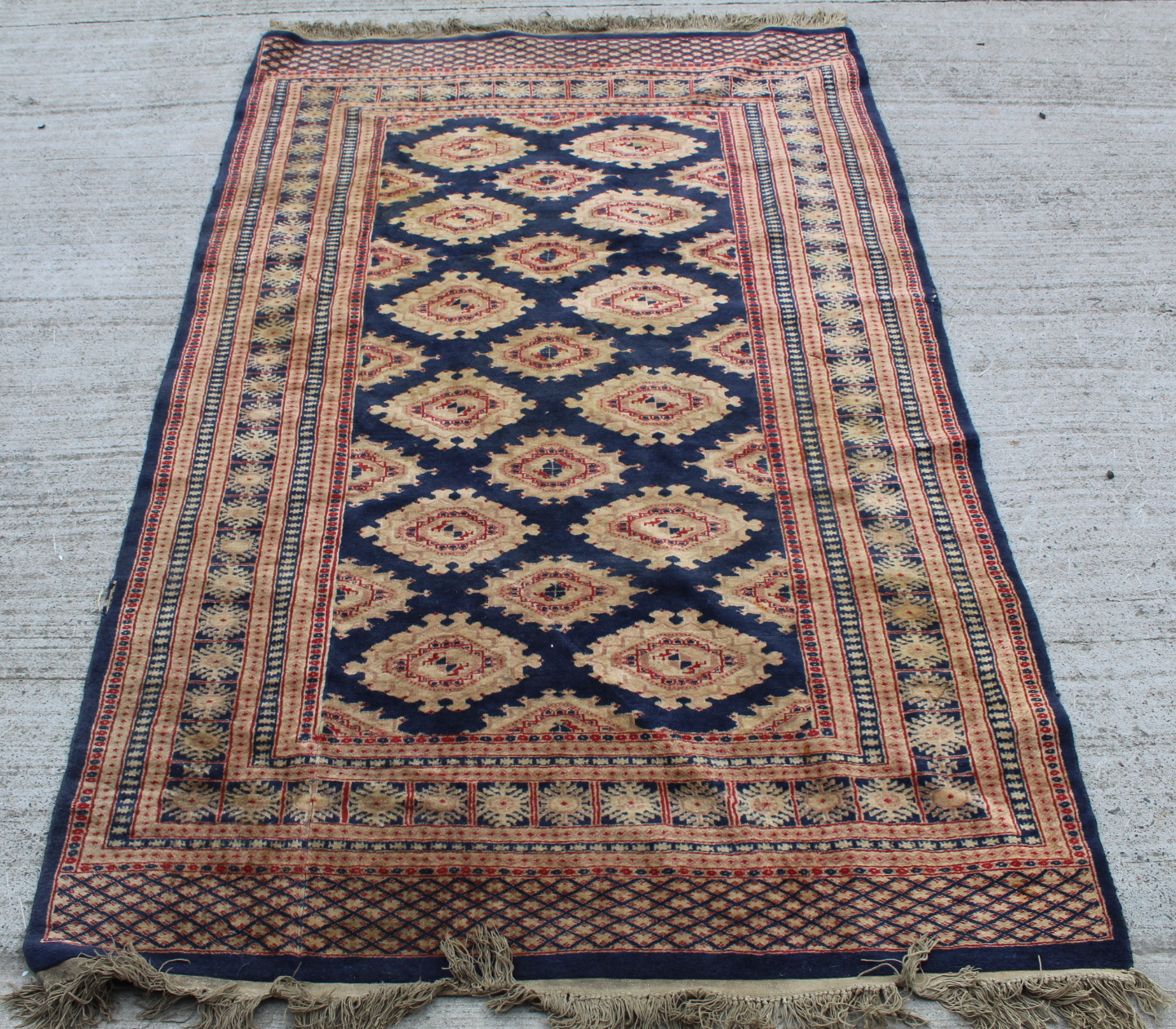 Eastern wool rug with multiple hooked octagonal medallions on blue field, 201cm x 124cm.