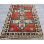 Turkish wool on wool rug with double cruciform medallion and geometric borders in red, yellow, blue,