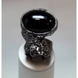 Yves Saint Laurent "Arty" cocktail ring in white metal with black oval cabochon, size Q, with