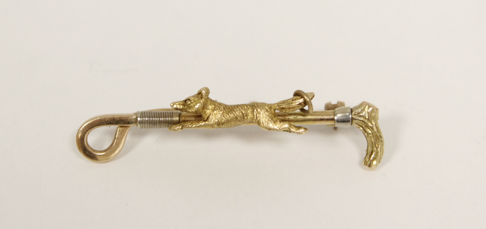 Gold riding crop and fox brooch, 14k. 6g.