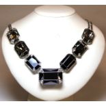 Swarovski crystal necklace set with seven large lozenge shaped crystals in black, pale green and