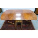 Mahogany drop flap dining table raised on square supports