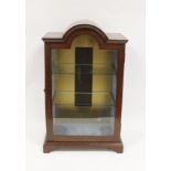Mahogany table top display cabinet enclosed by glazed arched panel door on bracket feet. 50cm