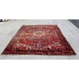 Very large 20th century Persian wool carpet with central stylised flowerhead hooked medallion.