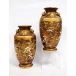 Pair of Satsuma vases elaborately decorated with worthies, marks to the base, 24cm high.  (2)