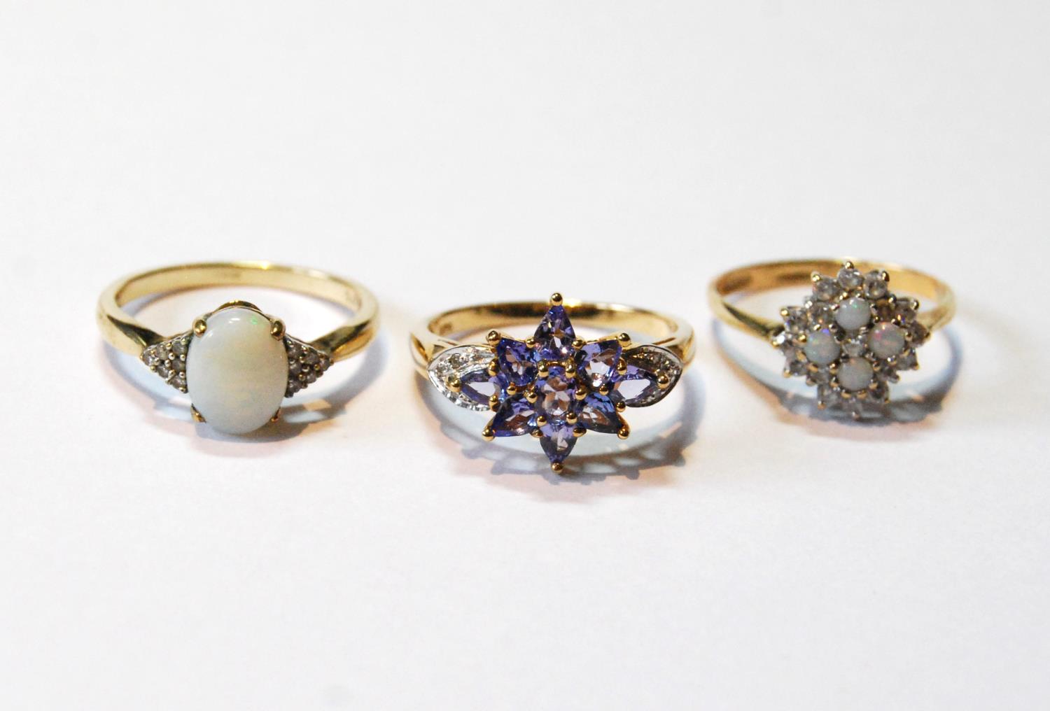 Opal cluster ring, another, and a tanzanite ring, all 9ct gold.  (3)