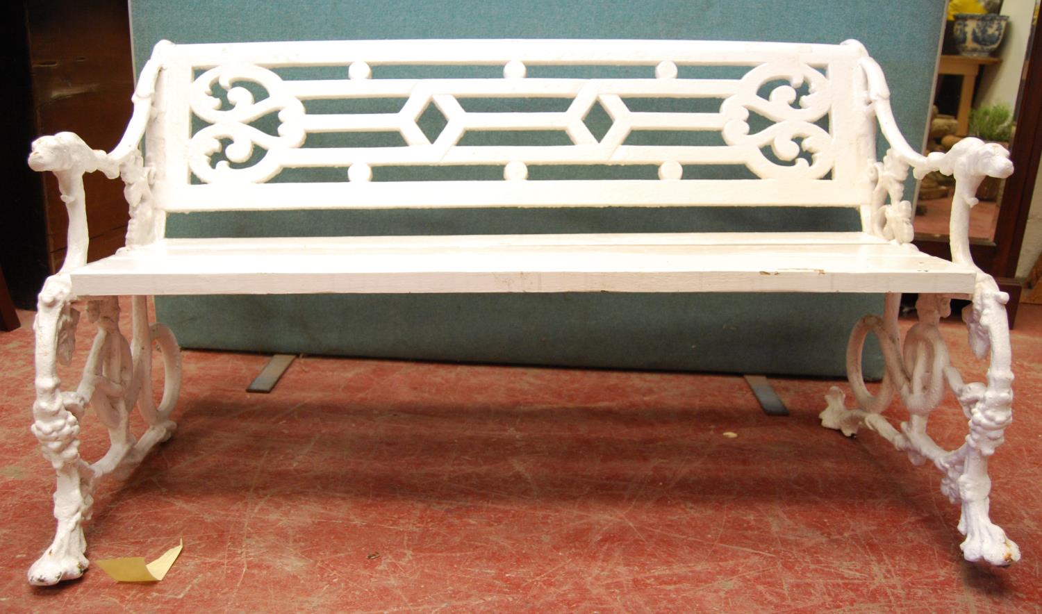 19th century cast iron garden bench, the fretwork back over scrolling vine leaf decoration, the arms