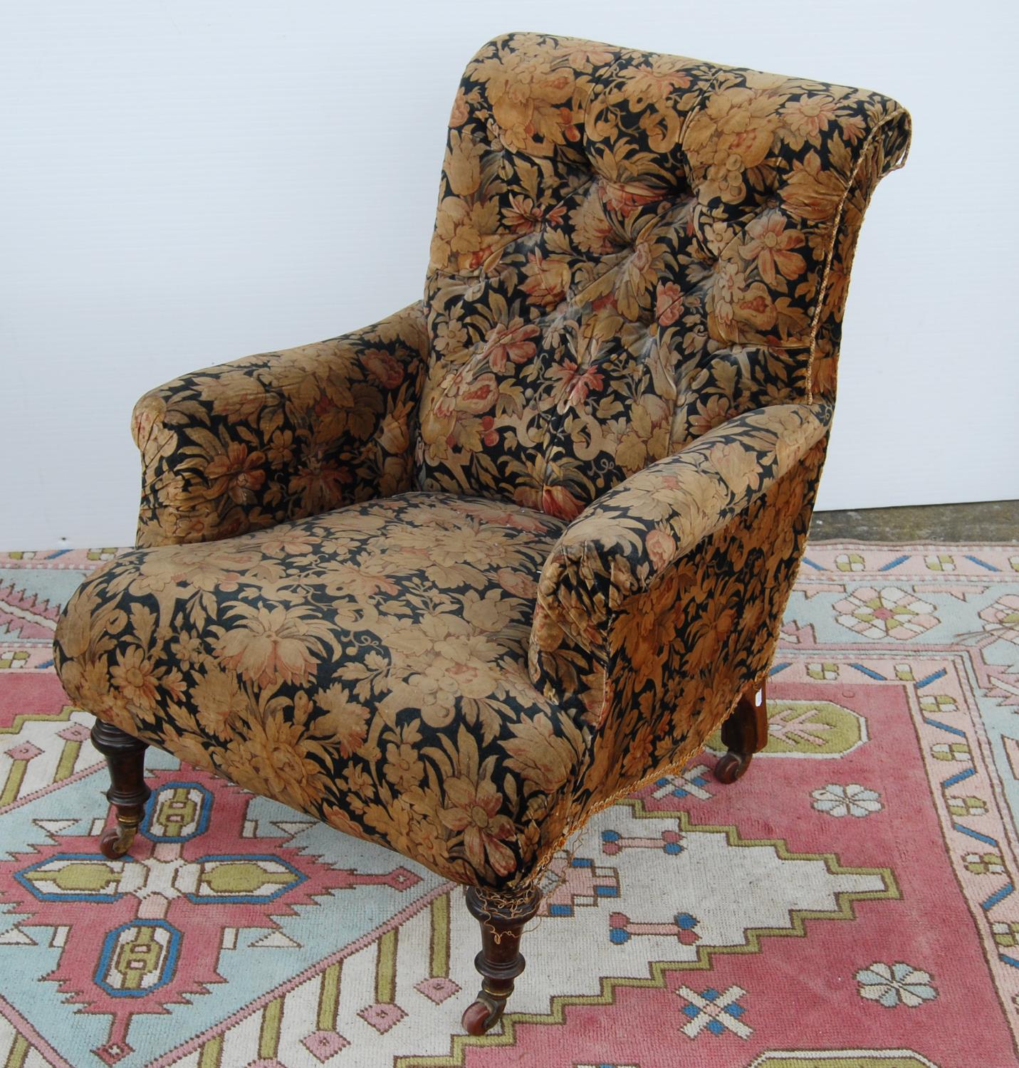 Victorian button-back armchair with cushioned arms, sprung seat, on tapering baluster legs