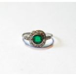 Diamond and emerald cluster ring with circular collet, eight-cut brilliants, size O½.