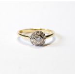 Diamond cluster ring with collet-set brilliant, approximately .5ct, and others smaller, in 18ct