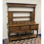 Attractive 18th century and later oak dresser, the plate rack flanked by two panelled door cupboards