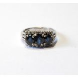 Dress ring with three oval sapphires within a border of tiny eight-cut diamonds, in white gold,