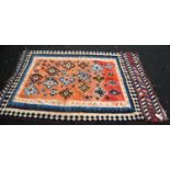 Kilim rug with diamond pattern over faded red ground and border, 215cm x 144cm.