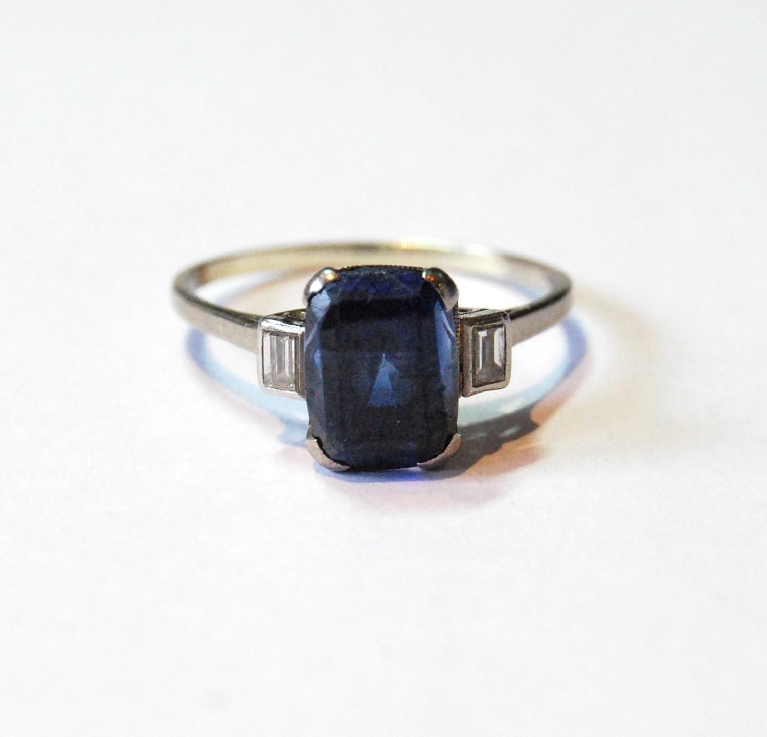 Ring with rectangular sapphire flanked by two baguette diamonds, in platinum, size O½.