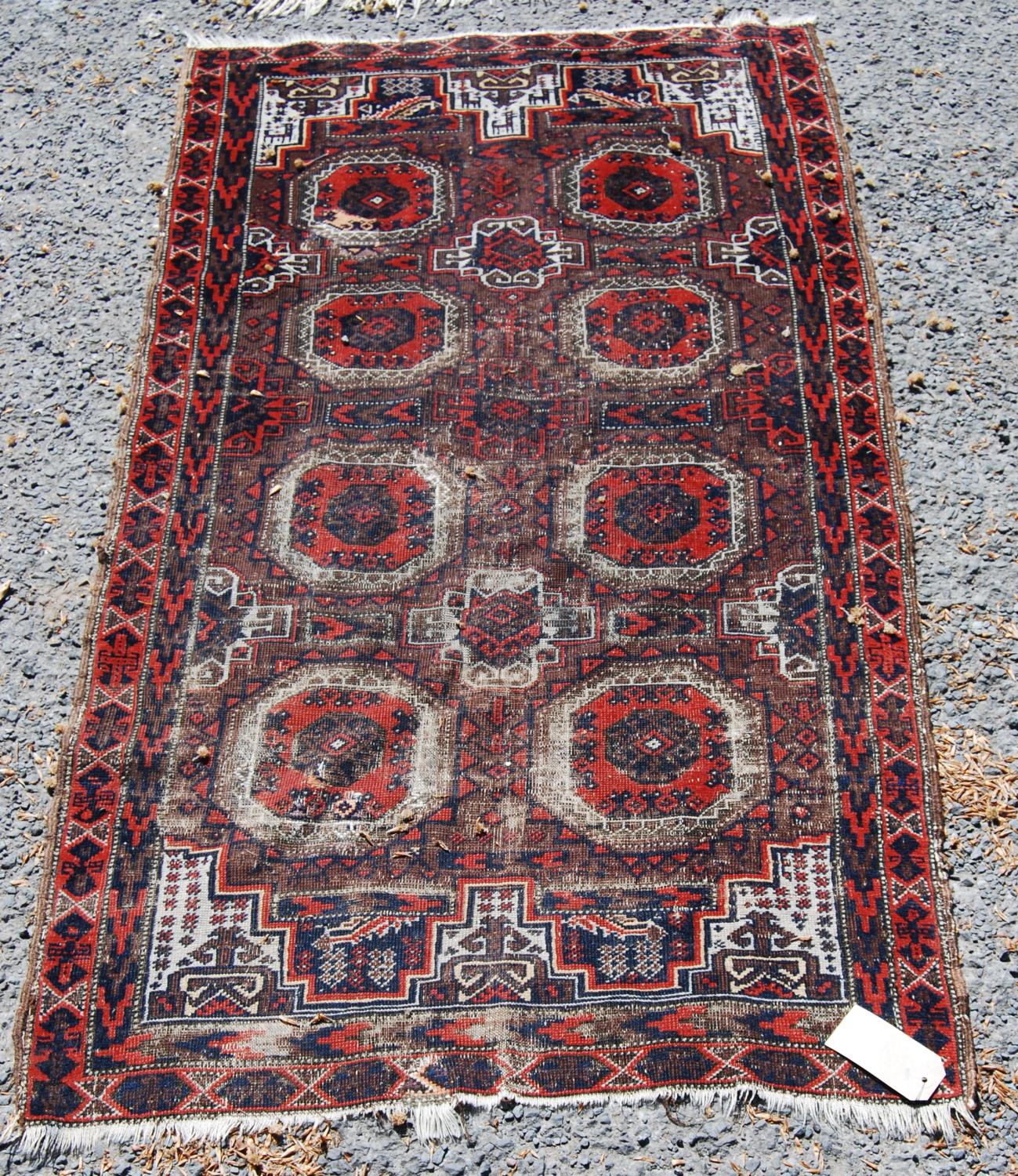 Afghan rug with two rows of four guls, spandrels over brown ground, 146cm x 82cm.