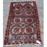 Afghan rug with two rows of four guls, spandrels over brown ground, 146cm x 82cm.