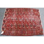 Tekke rug, the three rows of seven guls over red ground with rosette border, retail label for Harvey