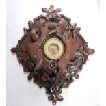 Victorian carved Black Forest wall panel barometer adorned with oak leaves, game and shooting items,