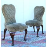 Pair of George II style side chairs, each with upholstered shaped back, sprung stuff-over seat, on