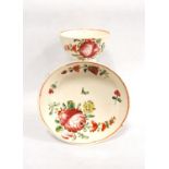 Tea bowl and saucer, each with floral decoration and red rim, 13cm diameter and 8.5cm diameter.  (2)