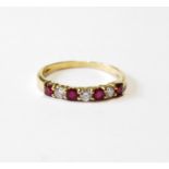 Eternity ring with four rubies and three diamond brilliants, in 18ct gold, size R.