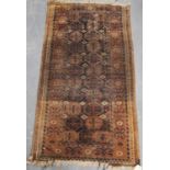 Eastern rug with two rows of eleven rosettes over faded brown ground, and triple border, 142cm x