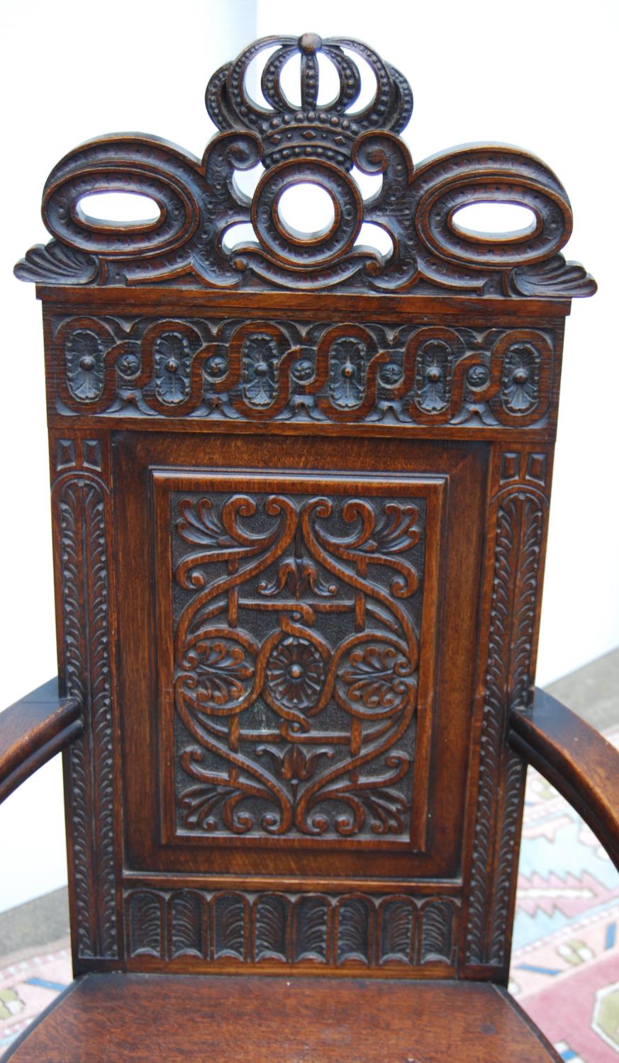 Jacobean-style oak throne chair, with crown carved finial over floral carved back panel, open - Image 2 of 3