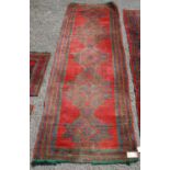 Turkoman long rug, the five alternating cruciform and diamond motifs over red ground and border,