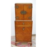 Edwardian oak cabinet on stand, the rectangular top above a cupboard with elaborate hinges and
