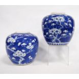 Two oriental blue and white ginger jars, each decorated with prunus bush, four character mark to the