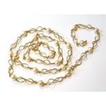 Gold necklace of entwined curb pattern with twenty cultured pearls, '750', gross 49g.