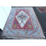 Indian carpet, the central diamond with cross pink spandrels, triple running floral border, 273cm