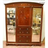 Edwardian mahogany and inlaid wardrobe, the arched projected cornice over quarter veneered and