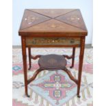 Edwardian rosewood and inlaid games table, the square envelope top over frieze drawer, on boxwood