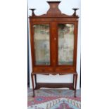 Art Nouveau mahogany and inlaid display cabinet, the shaped three-quarter gallery over central