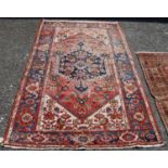 Vintage Persian rug, the central blue and floral panel over faded red ground, spandrels and triple