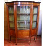 Edwardian mahogany and inlaid serpentine display cabinet, the projected moulded cornice over