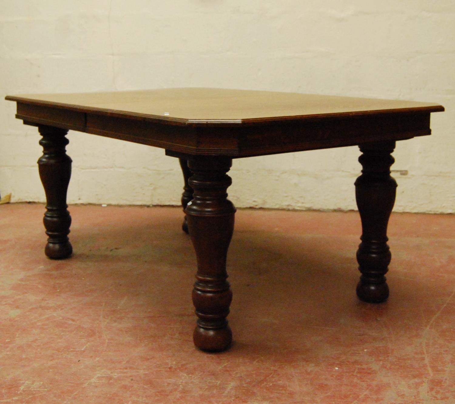 Late Victorian oak extending dining table, the moulded rectangular top with canted corners, on