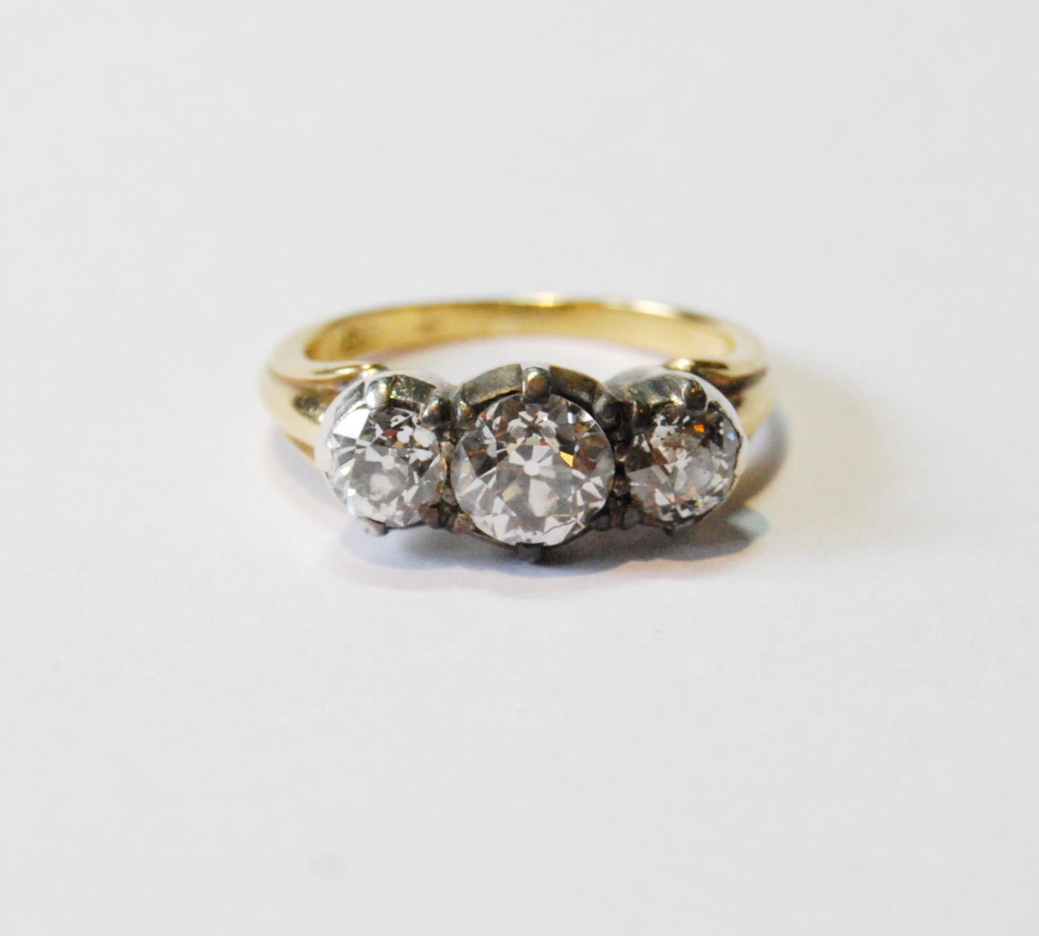 Antique diamond three-stone ring with old-cut brilliants, approximately .9ct and .6ct, in silver