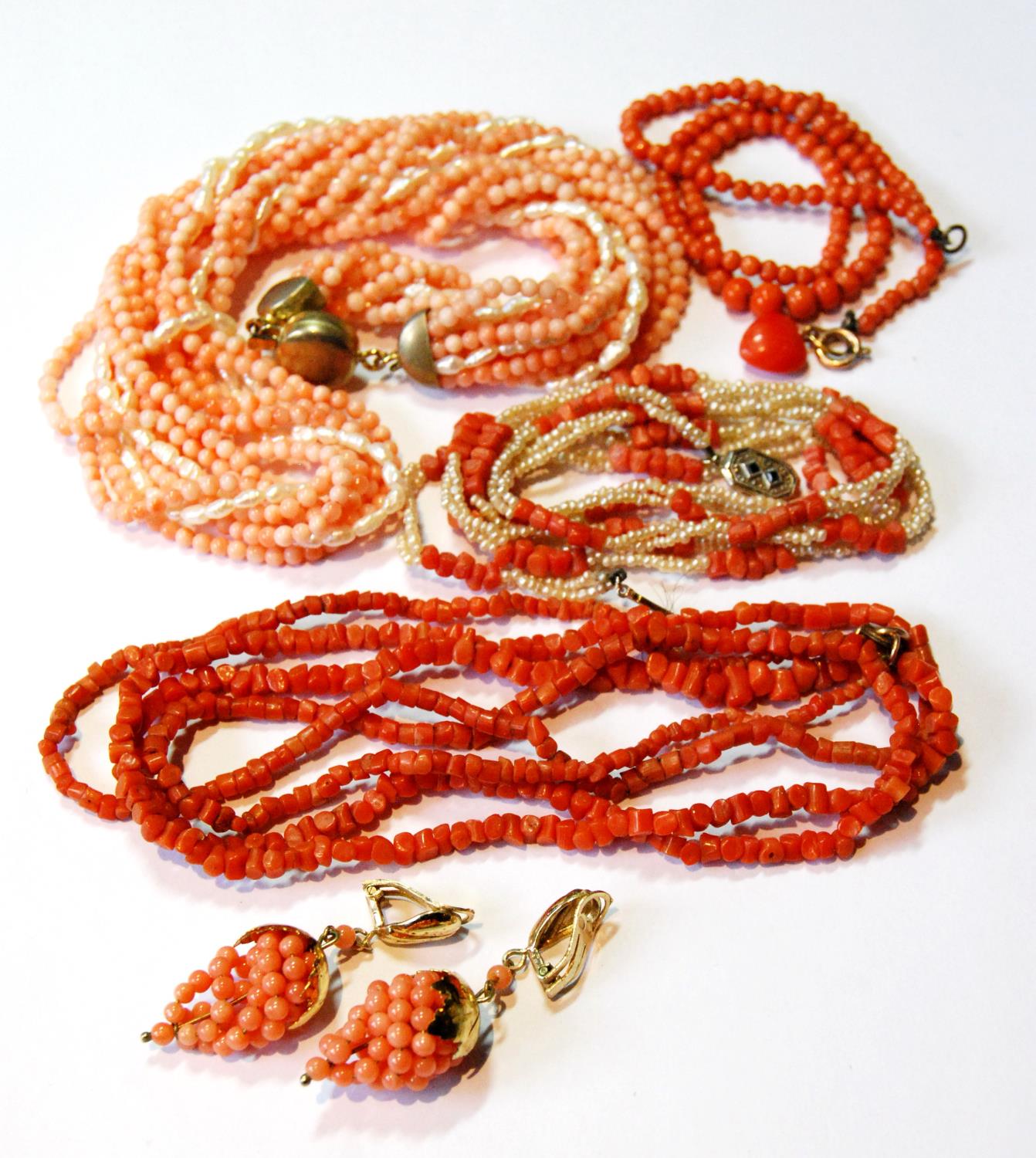 Two coral necklets, another with pearls and other similar items.