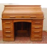 Oak roll-top desk, the tambour front enclosing a fitted interior, kneehole drawer flanked by banks