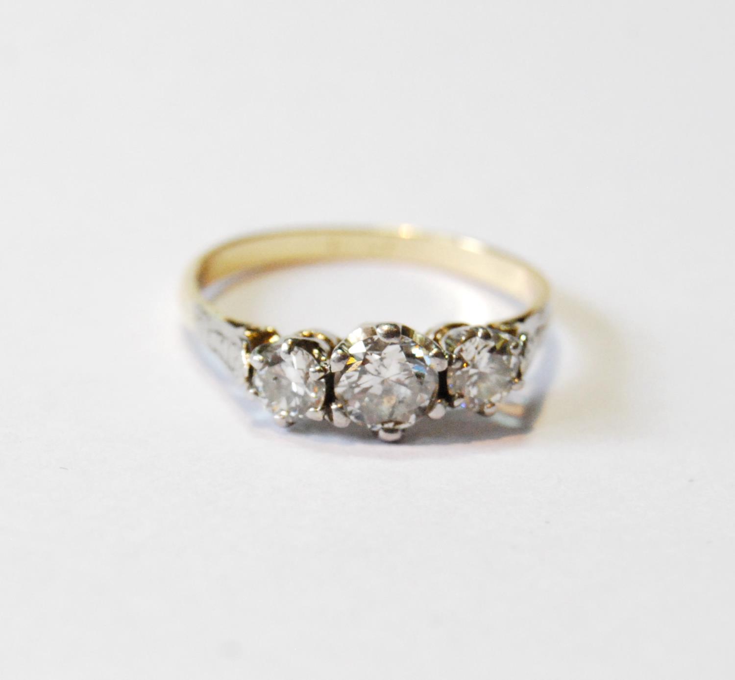 Diamond three-stone ring, the largest brilliant approximately .6ct, in gold, '18ct', size R.