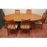 Kofod-Larsen for G Plan dining table and six chairs, the oval extending top on shaped legs, 162cm