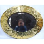 Aesthetic movement oval brass wall mirror decorated with embossed vine leaves and grapes, rivet